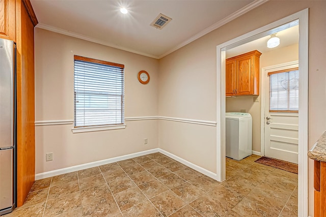 washroom featuring crown molding, cabinets, plenty of natural light, and washer / dryer