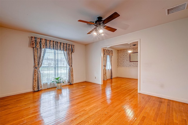 spare room featuring light hardwood / wood-style flooring and ceiling fan