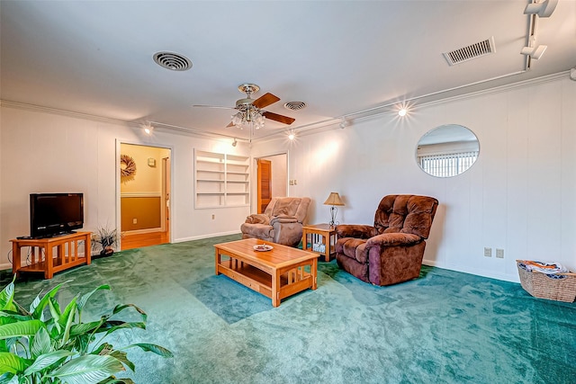 carpeted living room featuring crown molding, ceiling fan, track lighting, and built in features