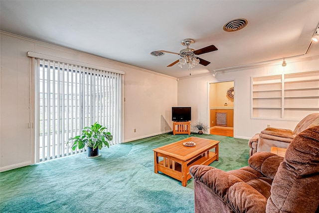 carpeted living room featuring crown molding, ceiling fan, and built in features