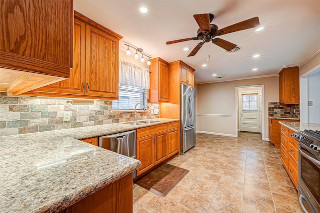 kitchen featuring tasteful backsplash, sink, light stone counters, stainless steel appliances, and crown molding