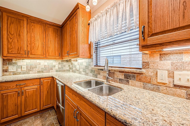 kitchen with light stone counters, sink, backsplash, and dishwasher