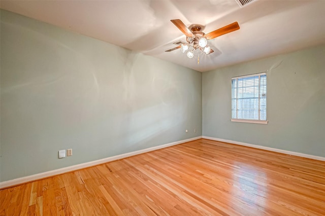 empty room with ceiling fan and light hardwood / wood-style flooring