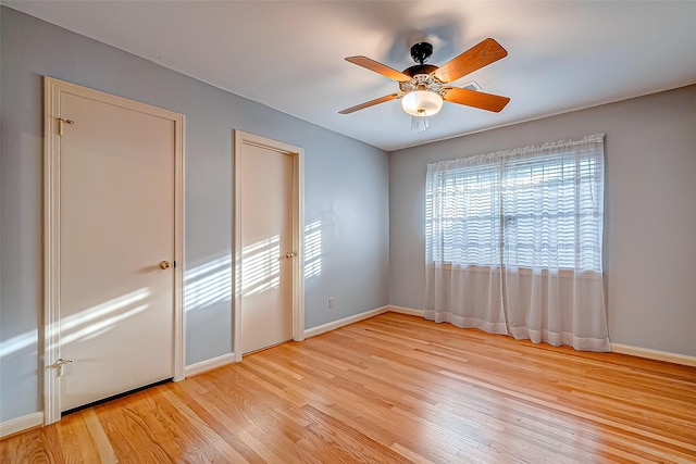 unfurnished bedroom with ceiling fan and light hardwood / wood-style flooring