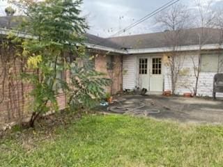 rear view of property featuring a yard