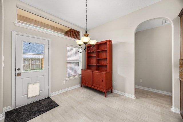 entryway featuring an inviting chandelier