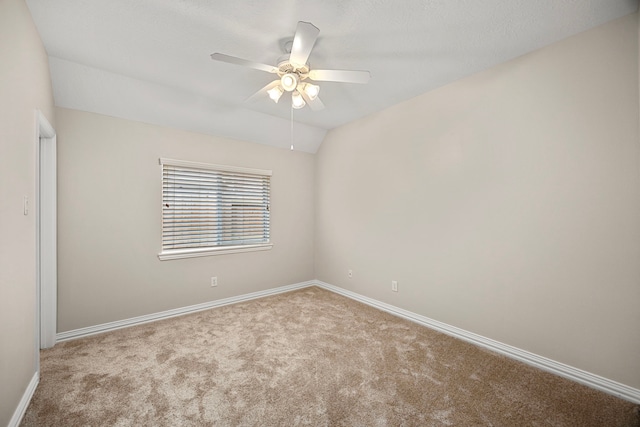 unfurnished room with ceiling fan, vaulted ceiling, and light carpet