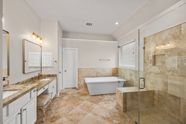 bathroom featuring shower with separate bathtub, tile walls, and vanity