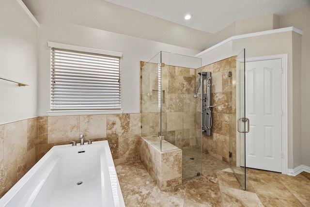 bathroom featuring separate shower and tub