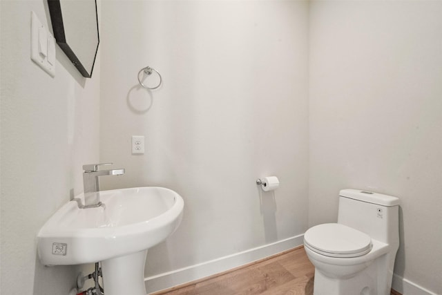 bathroom with sink, wood-type flooring, and toilet