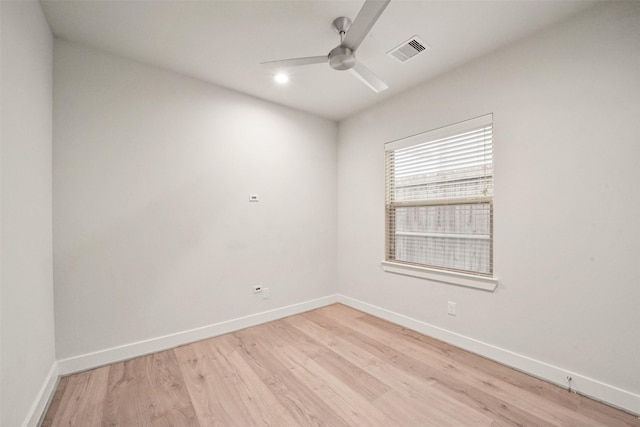 spare room featuring light hardwood / wood-style flooring and ceiling fan