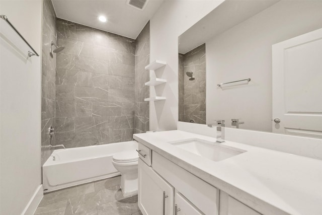 full bathroom with tiled shower / bath combo, vanity, and toilet