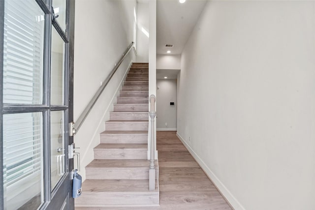 staircase featuring wood-type flooring