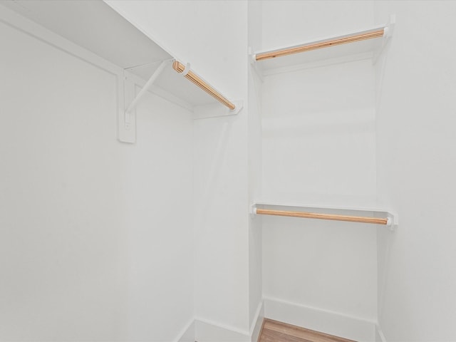 walk in closet featuring hardwood / wood-style floors