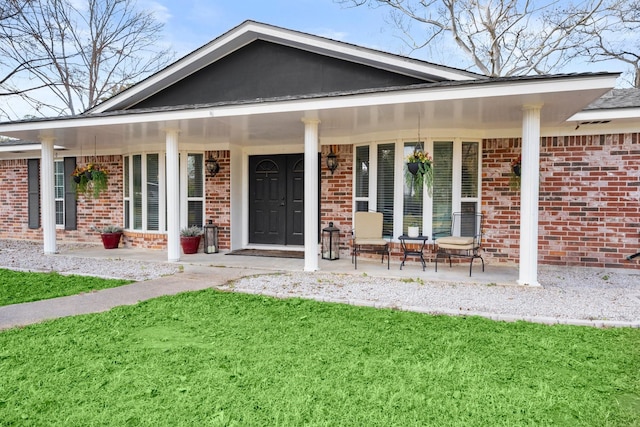 exterior space featuring covered porch and a lawn