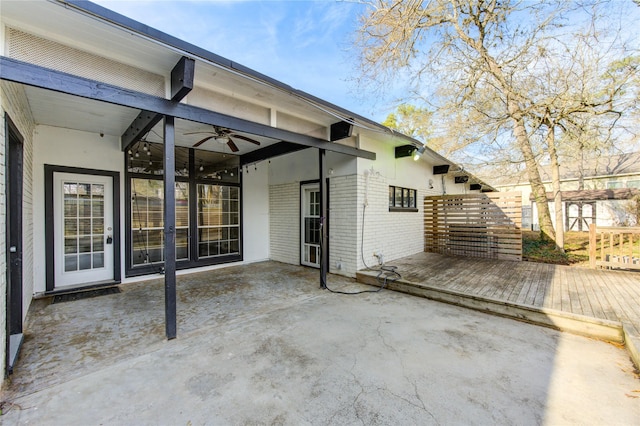 exterior space with a wooden deck, ceiling fan, and a patio