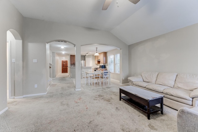 carpeted living room featuring vaulted ceiling and ceiling fan