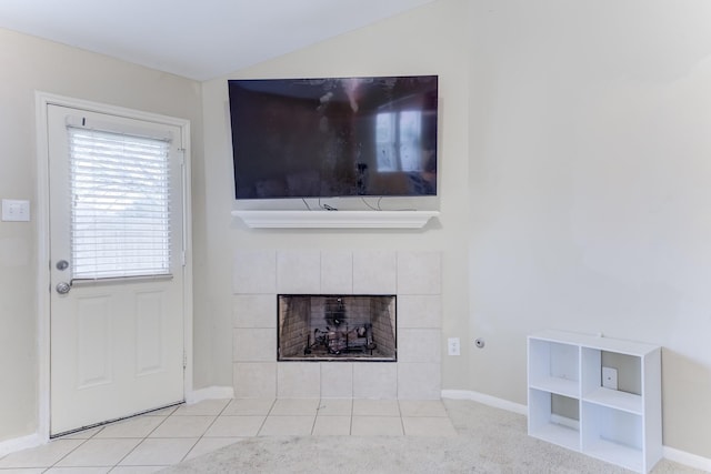 unfurnished living room with a tile fireplace and light tile patterned floors