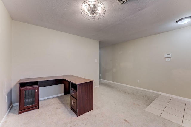 home office with light colored carpet and a textured ceiling