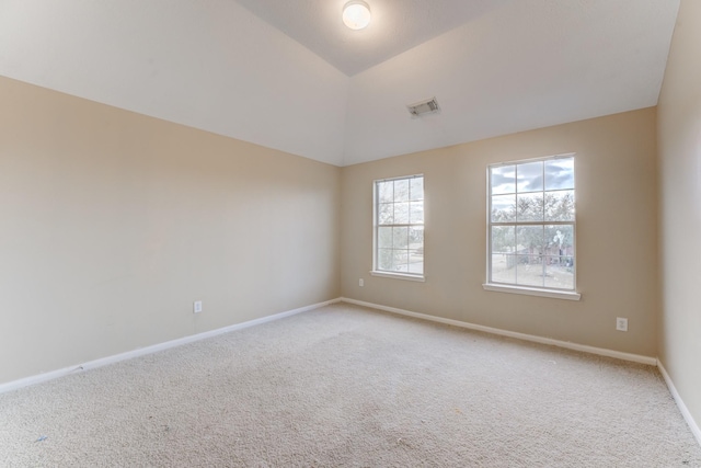 empty room featuring lofted ceiling and carpet floors