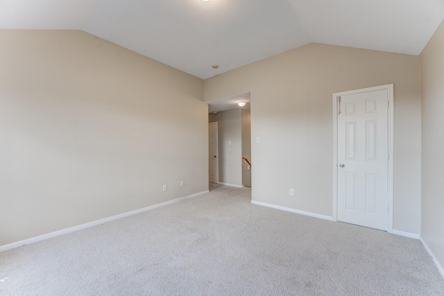 unfurnished bedroom with lofted ceiling and light colored carpet