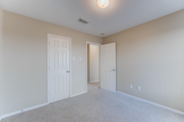 unfurnished bedroom featuring light colored carpet