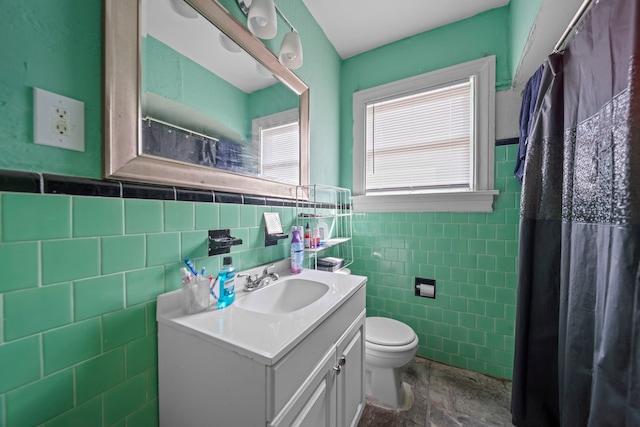 bathroom featuring vanity, tile walls, a shower with shower curtain, and toilet