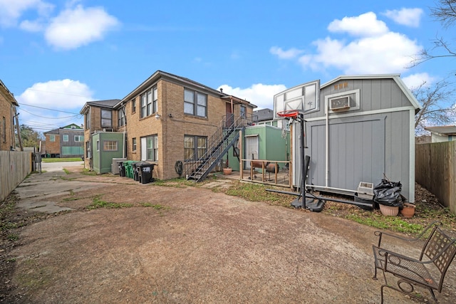 back of house featuring a shed