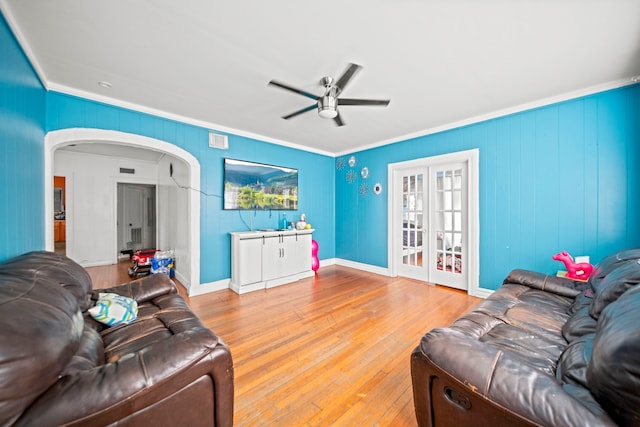 living room with french doors, ornamental molding, ceiling fan, and light hardwood / wood-style flooring