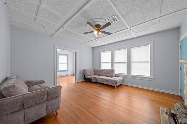 living room with hardwood / wood-style floors and ceiling fan