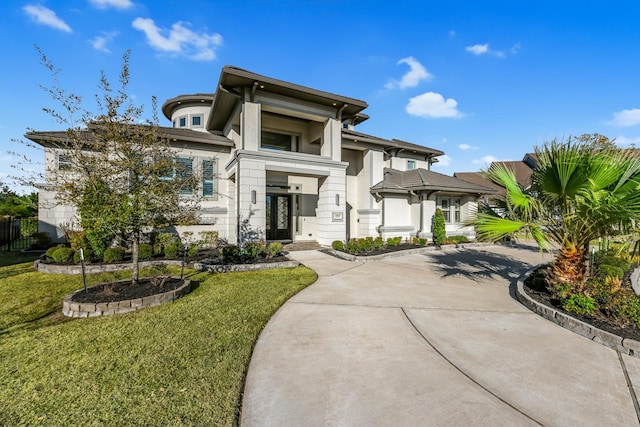 prairie-style home featuring a front lawn