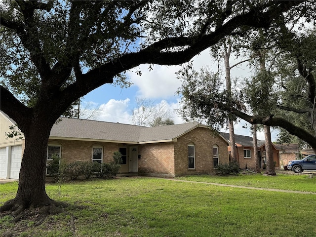 ranch-style home with a garage and a front yard