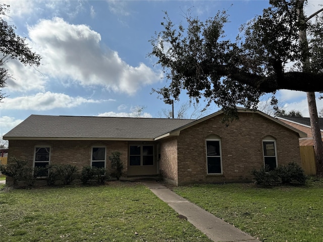 ranch-style home with a front lawn