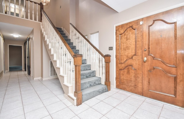 tiled foyer entrance with a high ceiling