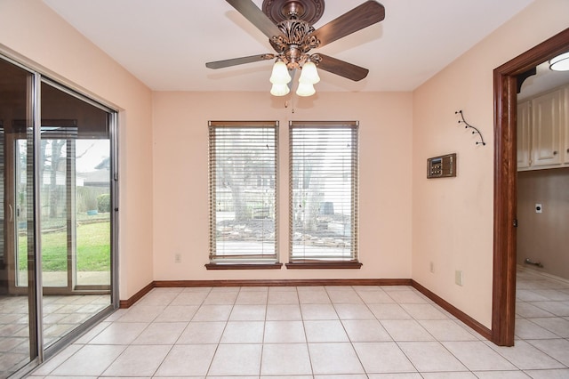 unfurnished dining area featuring light tile patterned floors and ceiling fan