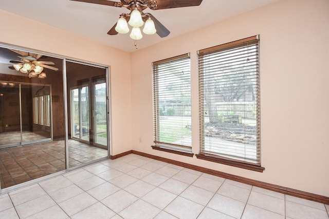 unfurnished room featuring ceiling fan and light tile patterned flooring