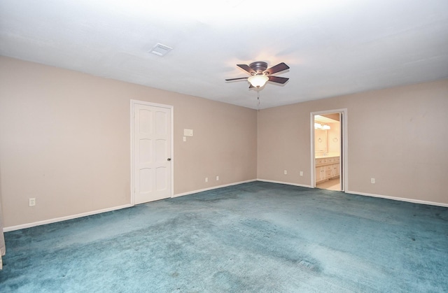 carpeted spare room with ceiling fan