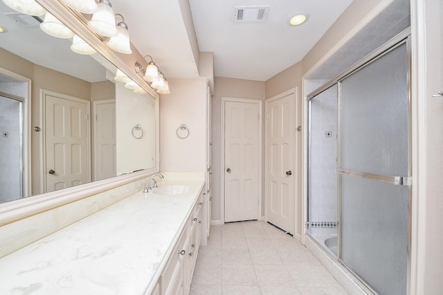 bathroom featuring vanity, tile patterned flooring, and a shower with door