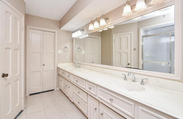 bathroom with vanity, tile patterned floors, and walk in shower