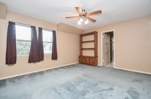 empty room with light carpet, vaulted ceiling, and ceiling fan