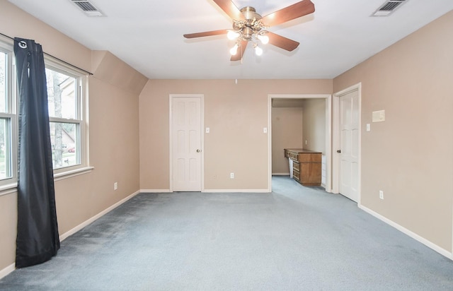 unfurnished bedroom with ceiling fan and light carpet