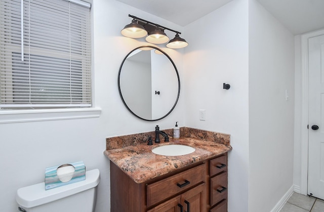 bathroom featuring vanity, tile patterned flooring, and toilet