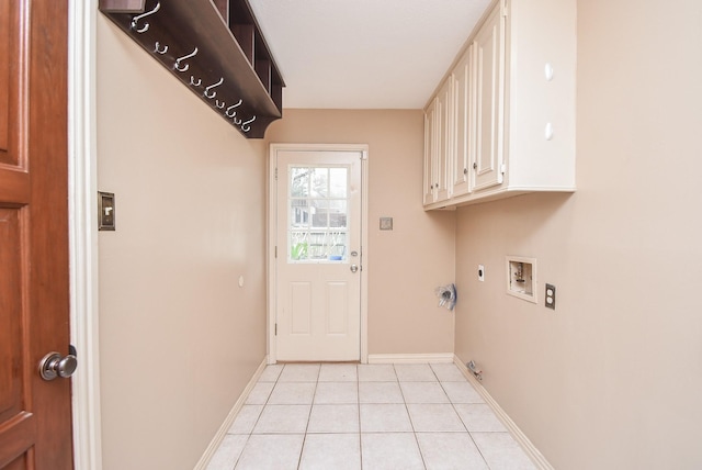 laundry room with cabinets, light tile patterned floors, hookup for a washing machine, electric dryer hookup, and hookup for a gas dryer