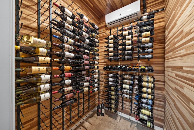 wine cellar with a wall mounted air conditioner and tile patterned flooring