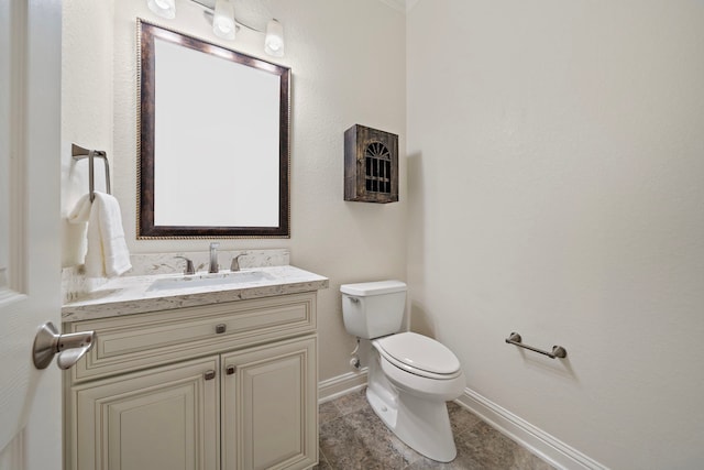 half bath with toilet, tile patterned floors, vanity, and baseboards