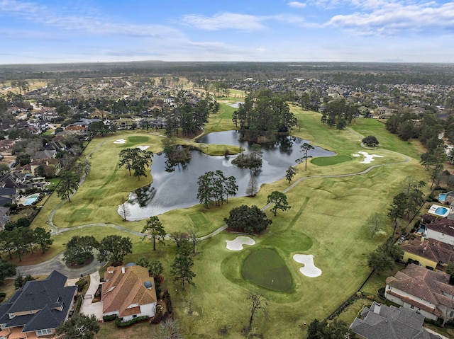 drone / aerial view with view of golf course, a water view, and a residential view