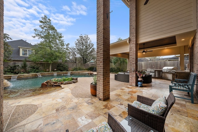 view of patio with a fenced in pool, an outdoor kitchen, area for grilling, ceiling fan, and a fenced backyard