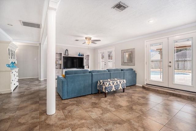 living room featuring decorative columns, ceiling fan, crown molding, a textured ceiling, and french doors