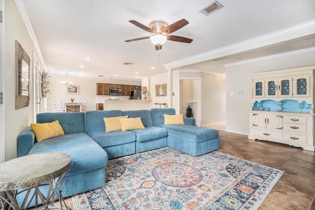 living room with ornamental molding, ceiling fan with notable chandelier, and dark tile patterned flooring