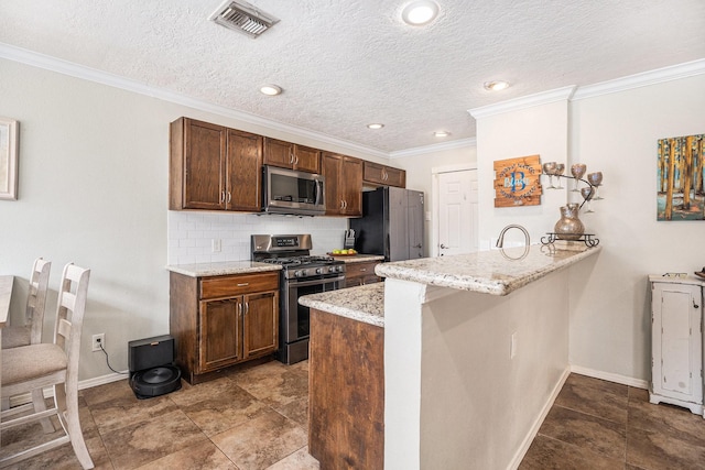 kitchen featuring light stone counters, crown molding, tasteful backsplash, kitchen peninsula, and stainless steel appliances